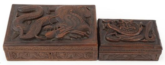Two oriental hardwood boxes carved with dragons, the largest 7cm H x 28cm W x 17cm D