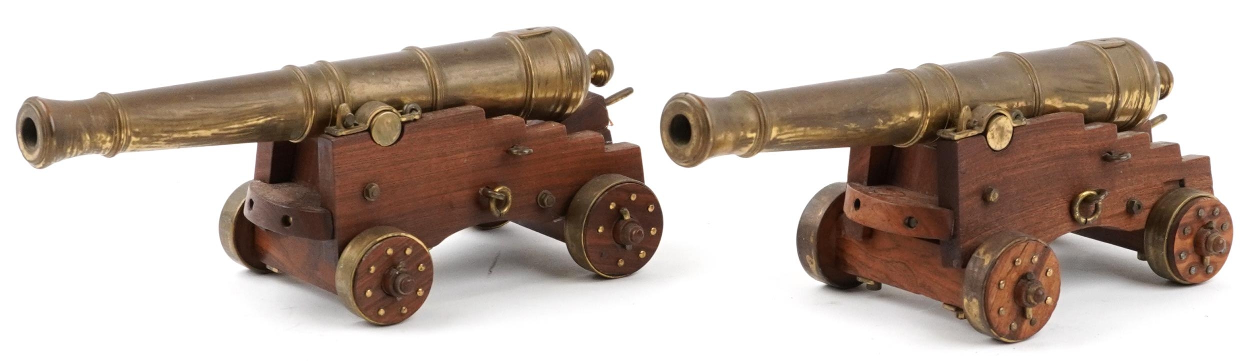 Pair of mid 20th century bronze and hardwood model table cannons, each 22cm in length PROVENANCE: