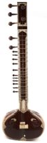 Indian hardwood, nut, ivorine and bone four string sitar, 126cm in length