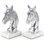 Pair of silvered metal and white marble horsehead bookends, each 23cm high