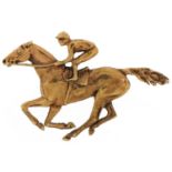 9ct gold brooch in the form of a jockey on horseback, 5cm wide, 7.7g