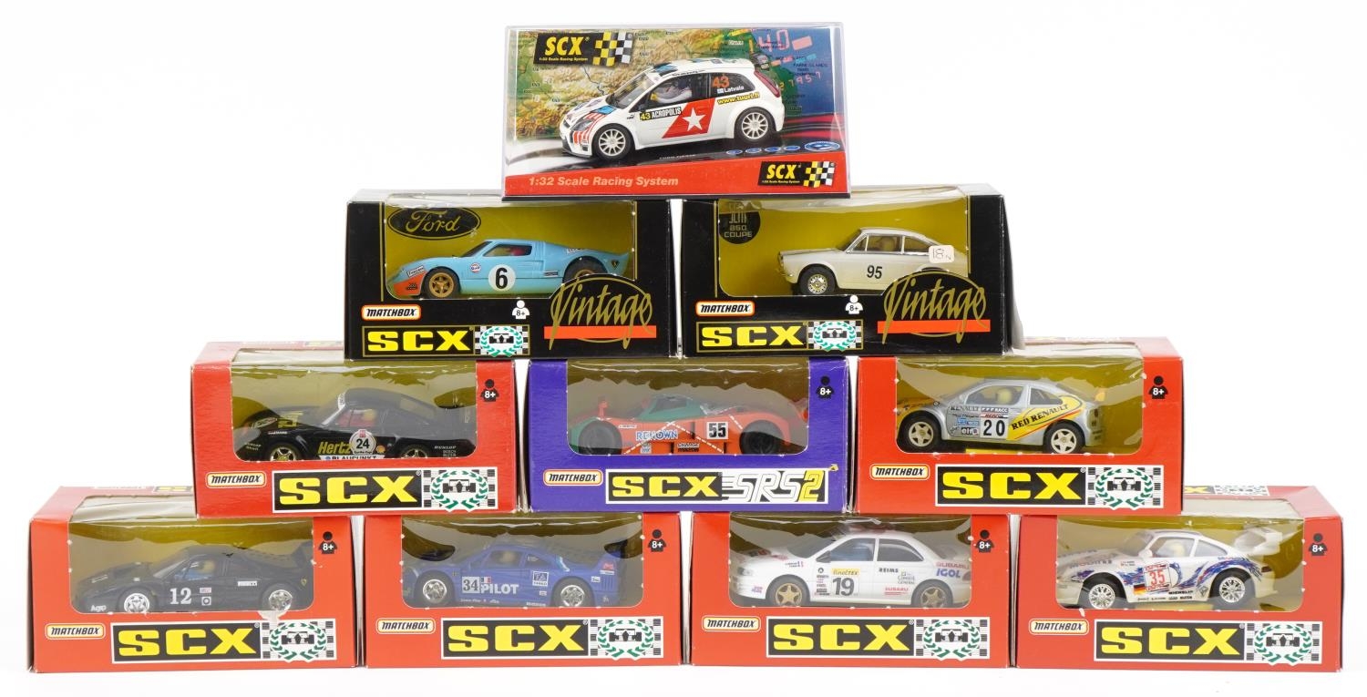 Ten Matchbox SCX 1:32 scale model slot cars with boxes and cases including Subaru Impreza, Porsche