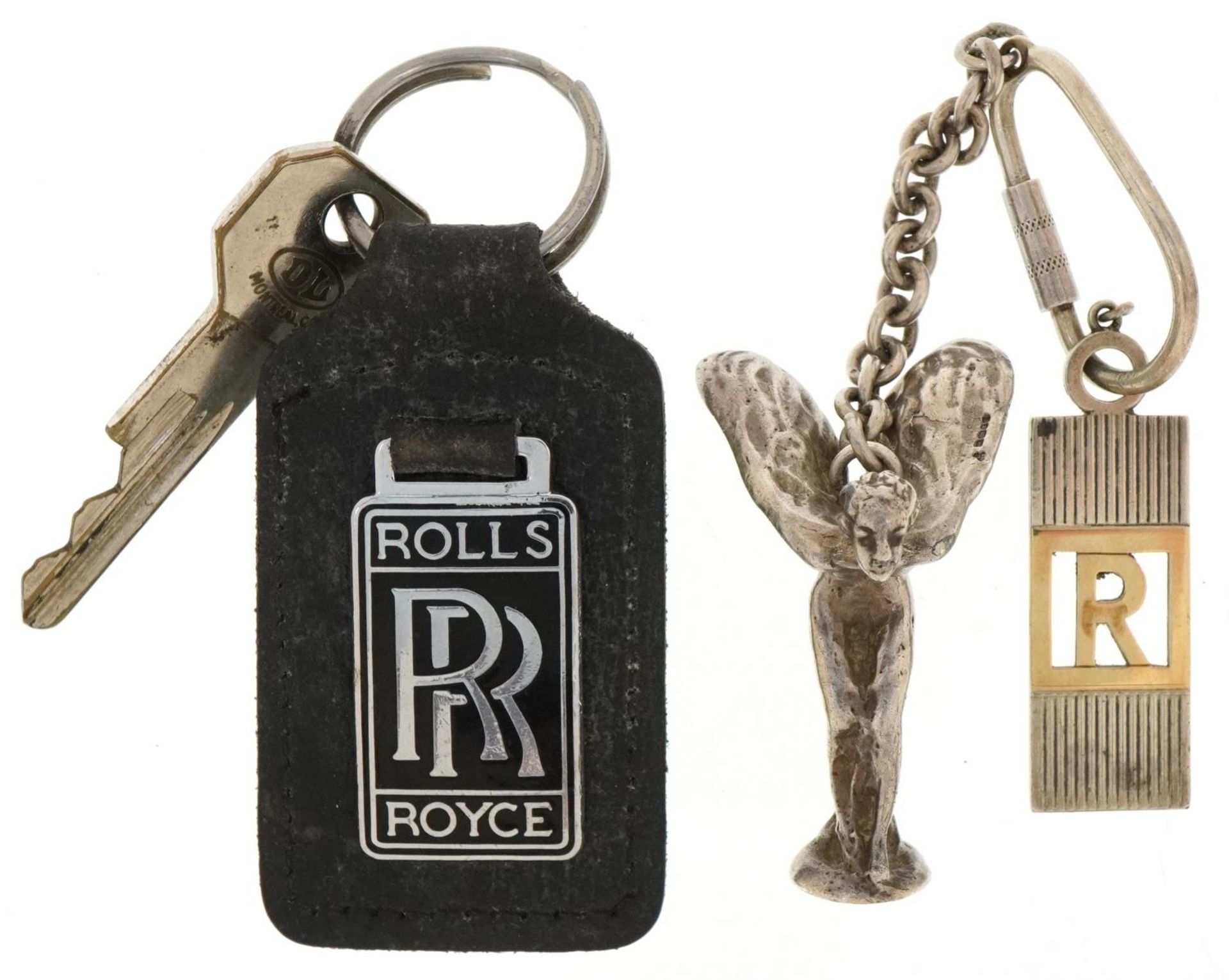 Three Rolls Royce keyrings, two silver, including Spirit of Ecstasy car mascot, the figure