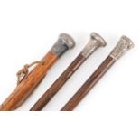 Three hardwood silver topped walking sticks with silver handles, 92cm in length