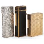 Three vintage pocket lighters, gold plated S J Dupont, silver plated Dunhill bark design and gold