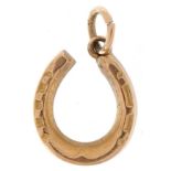9ct gold charm in the form of a lucky horseshoe, 1.4cm high, 1.1g