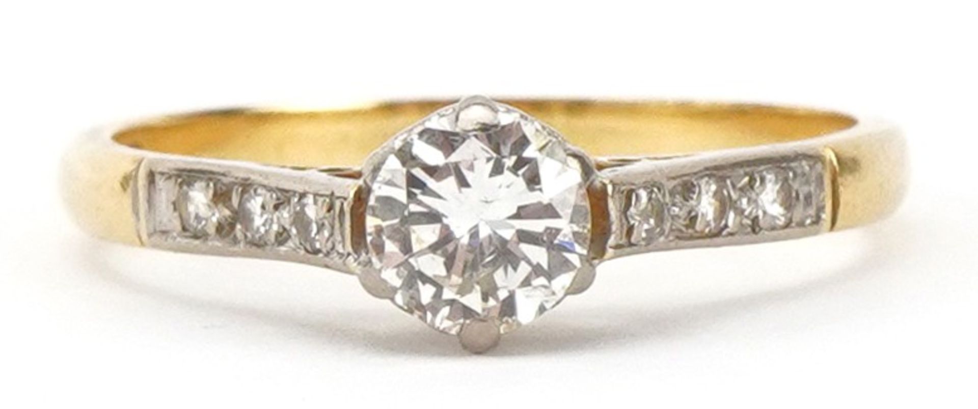 18ct gold and platinum diamond solitaire ring with diamond set shoulders, the central diamond