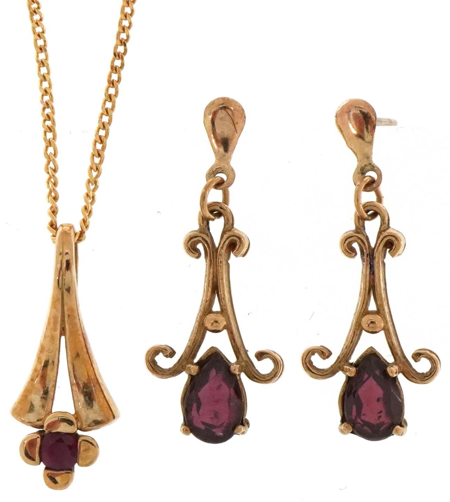 9ct gold ruby pendant on a 9ct gold necklace and a pair of 9ct gold garnet teardrop earrings, the