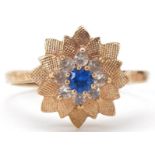 9ct gold blue and white spinel flower head ring, size Q/R, 3.0g