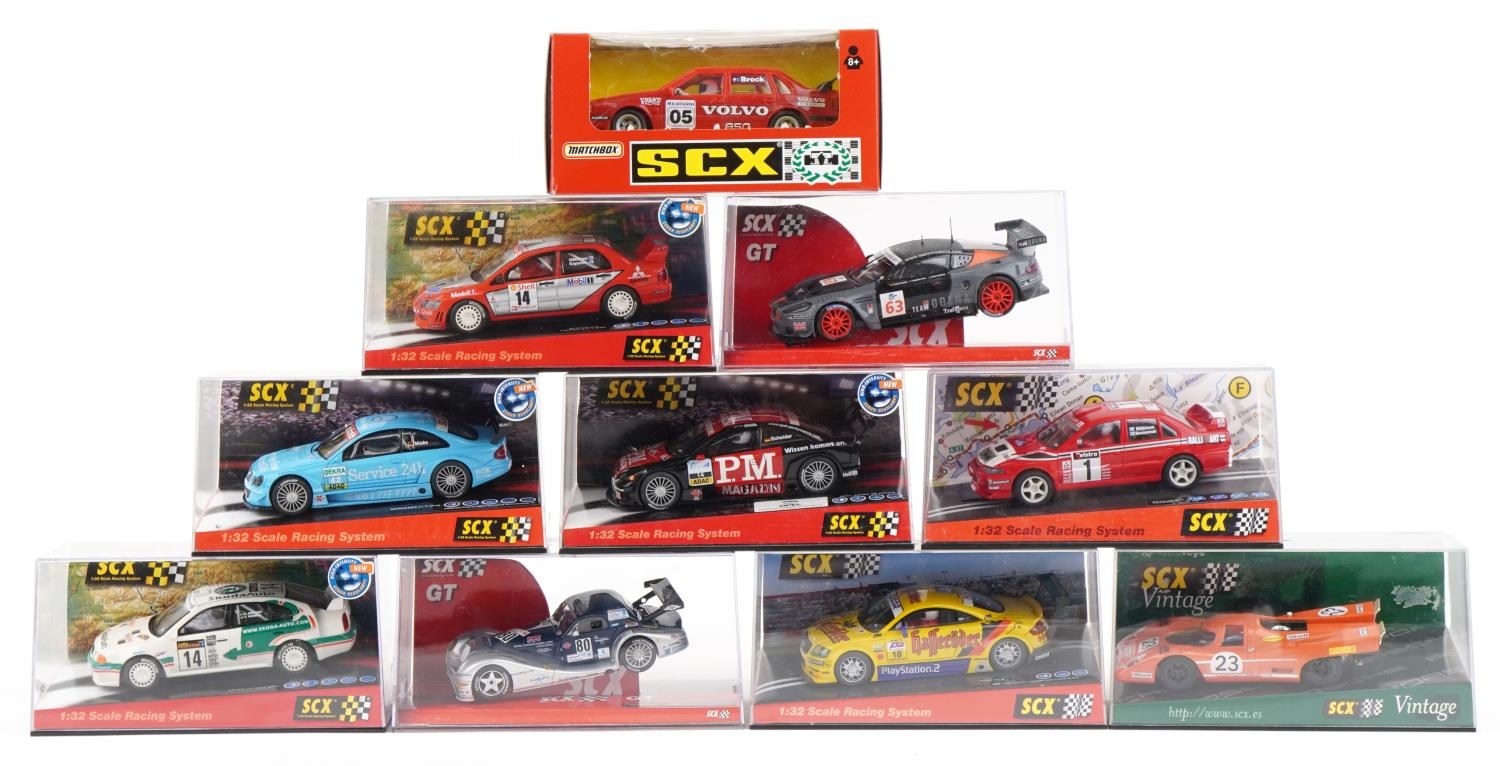 Ten Matchbox SCX 1:32 scale model slot cars with cases including Skoda Octavia WRC, Opel Astra V8