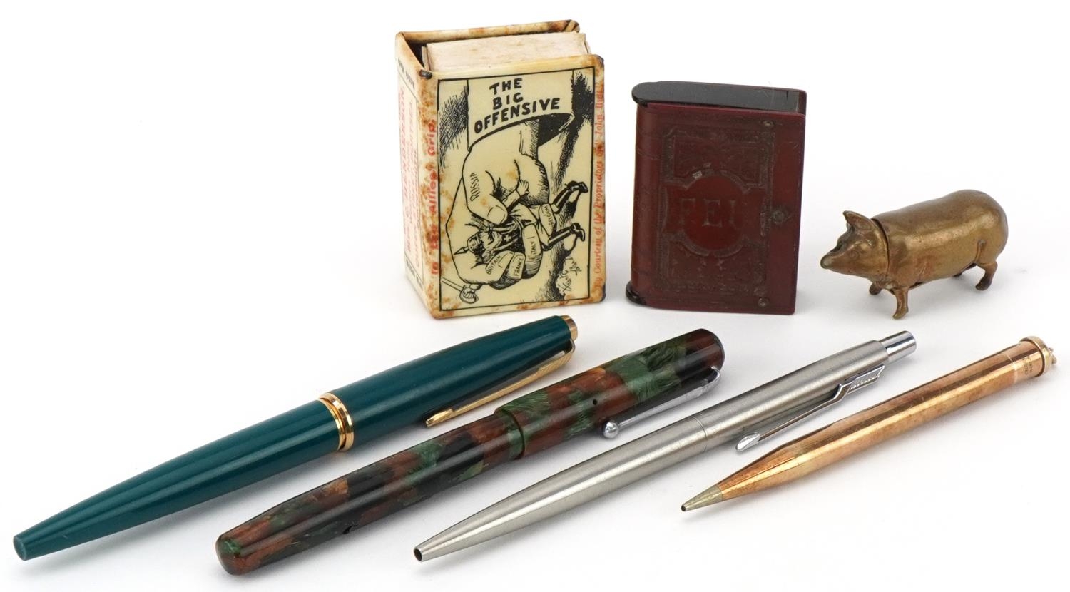 Fountain pens, brass pig vesta, vulcanite vesta, cigarette case, and a matchbox holder for The