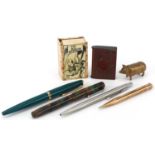 Fountain pens, brass pig vesta, vulcanite vesta, cigarette case, and a matchbox holder for The