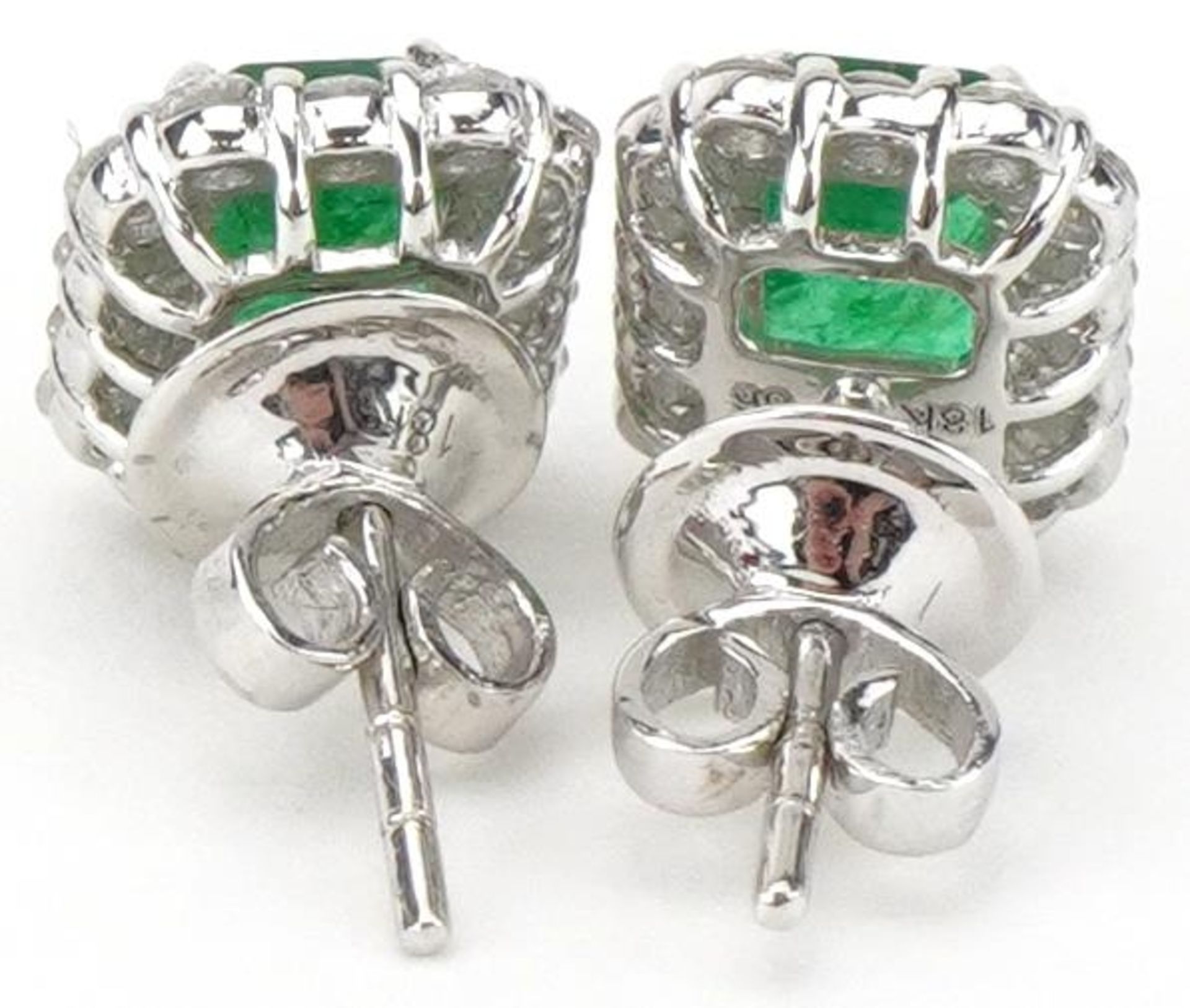 Pair of 18ct white gold emerald and diamond stud earrings, total diamond weight approximately 0.70 - Image 2 of 3
