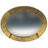 Arts & Craft brass oval wall mirror with bevelled glass, 75cm x 58cm