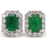 Pair of 18ct white gold emerald and diamond stud earrings, total diamond weight approximately 0.70