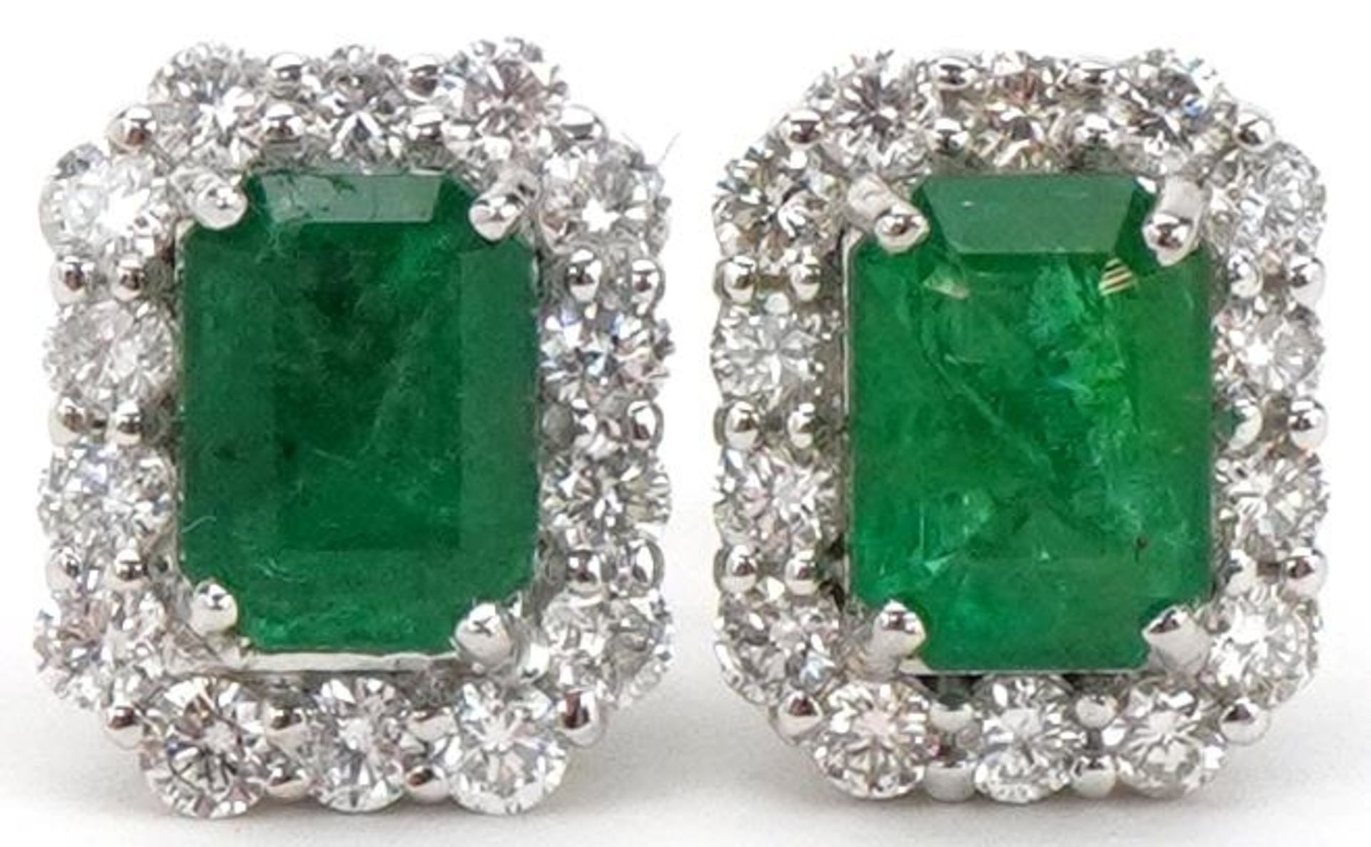 Pair of 18ct white gold emerald and diamond stud earrings, total diamond weight approximately 0.70