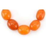 Butterscotch amber coloured graduated bead necklace, the largest bead approximately 18mm x 15mm in