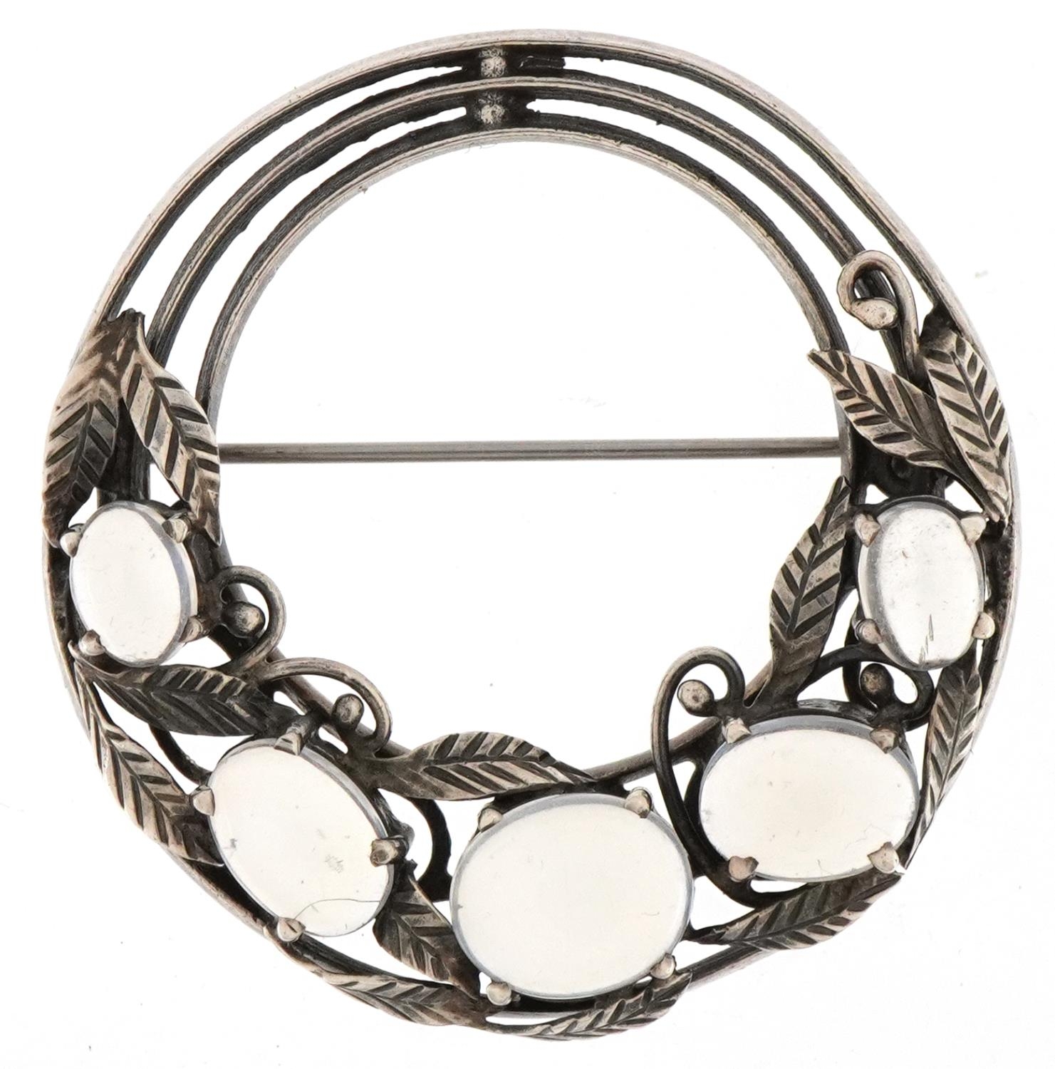 Attributed to Bernard Instone, Arts & Crafts silver floral brooch set with five cabochon moonstones,