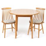 Ercol style lightwood drop end dining table with two stick back chairs, the table 74cm H x 55cm W