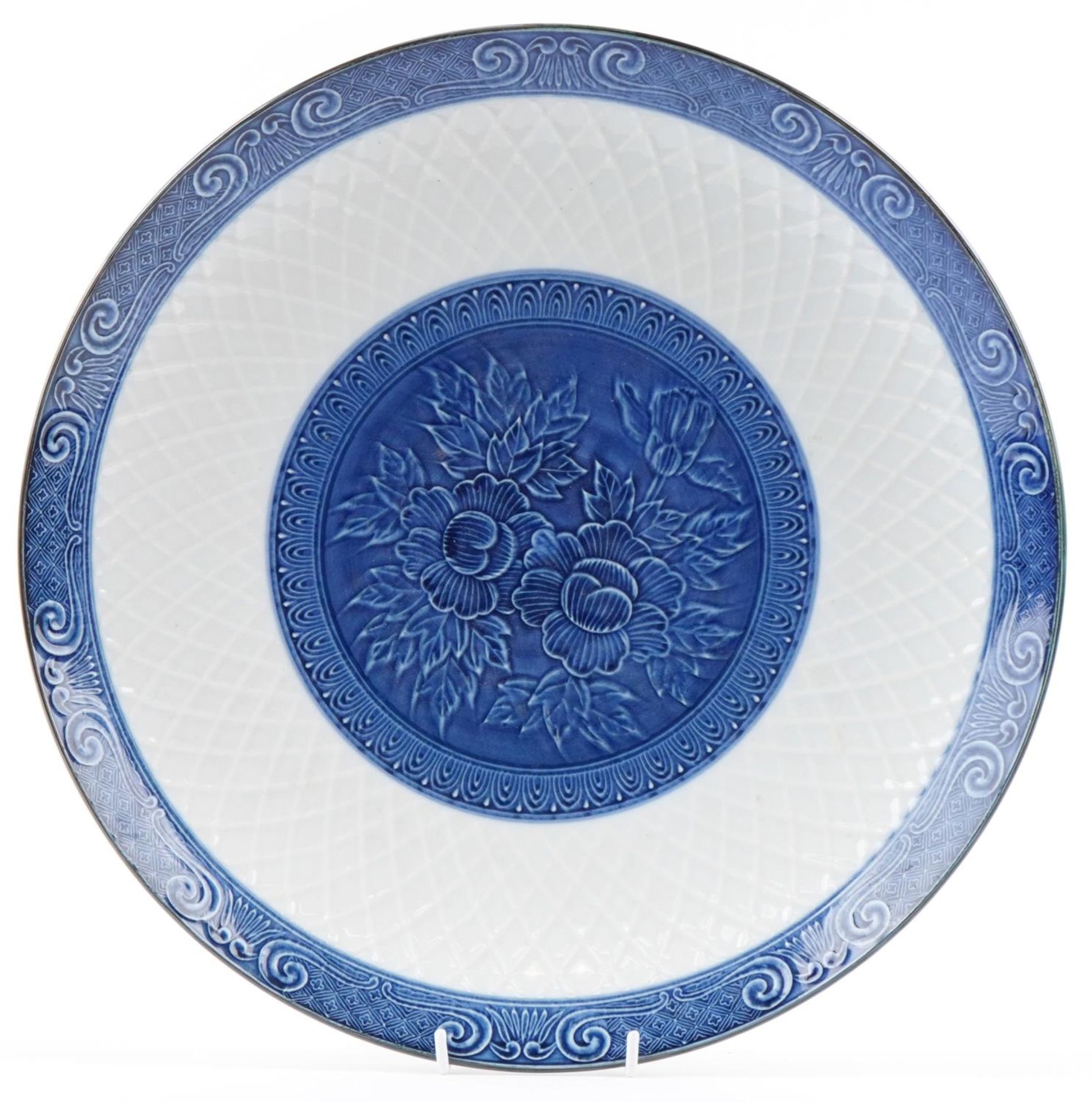 Large Japanese 20th century blue and white Arita charger, moulded with a lotus flower to the centre,