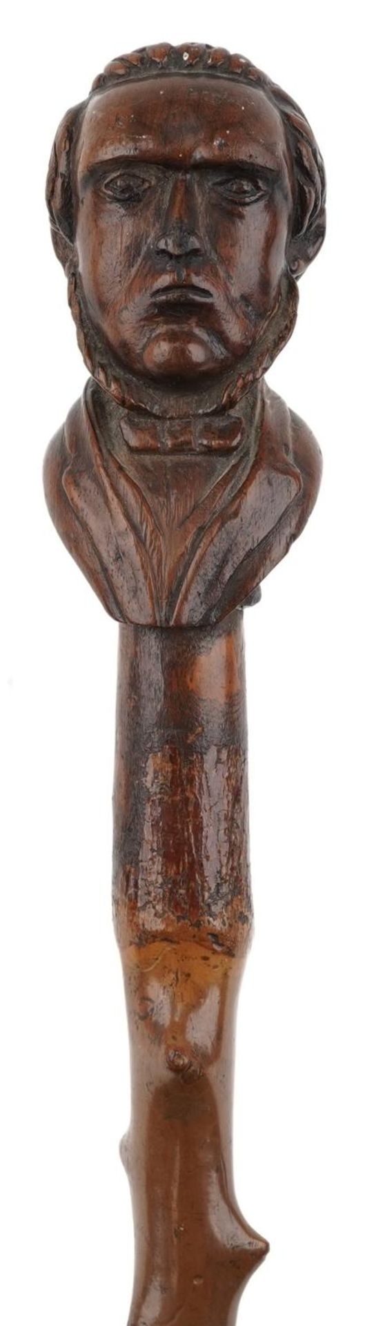 A 19th century knurled wood walking cane carved with a bust of a man, 88cm in length.