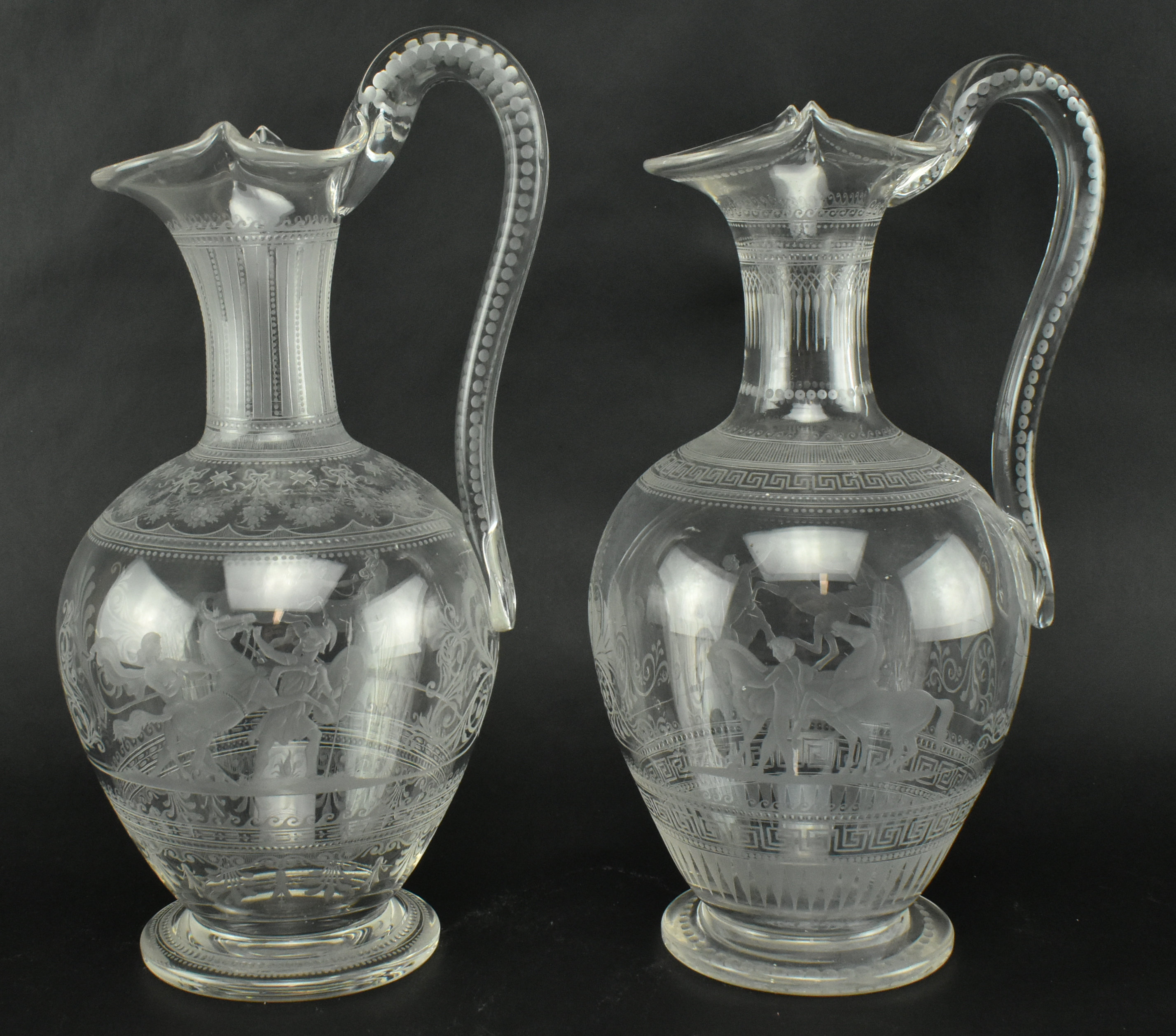 PAIR OF VICTORIAN CIRCA 1860 ENGRAVED GLASS EWERS