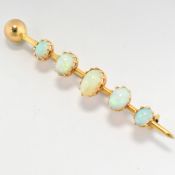 AN EARLY 20TH CENTURY 15CT GOLD & OPAL BROOCH PIN