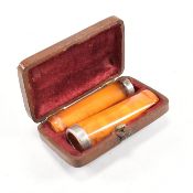 EDWARD VII CASED PAIR OF SILVER MOUNTED AMBER CHERROT HOLDERS