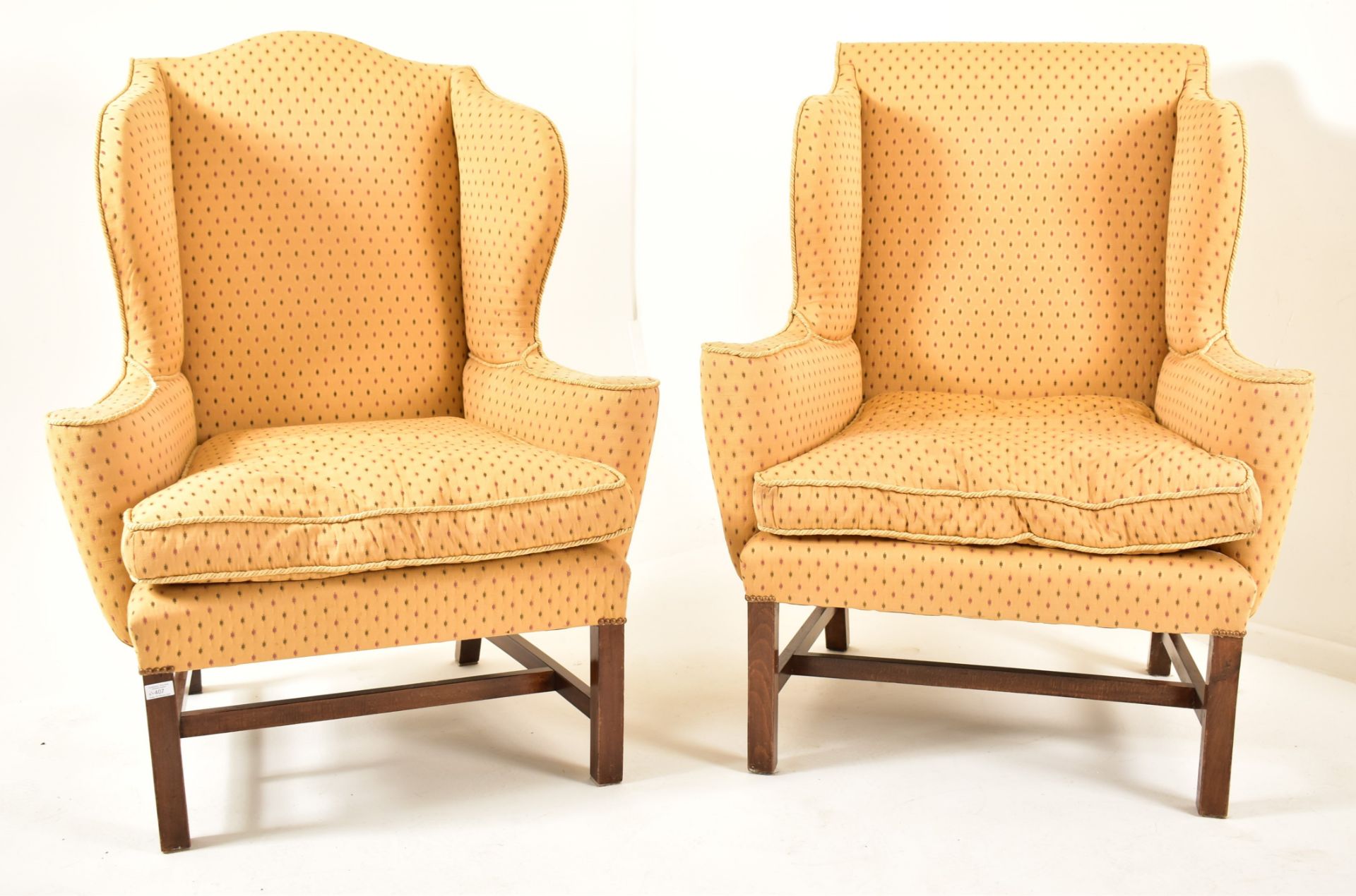 PAIR OF GEORGE III REVIVAL UPHOLSTERED WINGBACK ARMCHAIRS