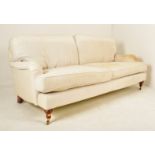 THREE SEATER SOFA IN THE MANNER OF HOWARD & SONS