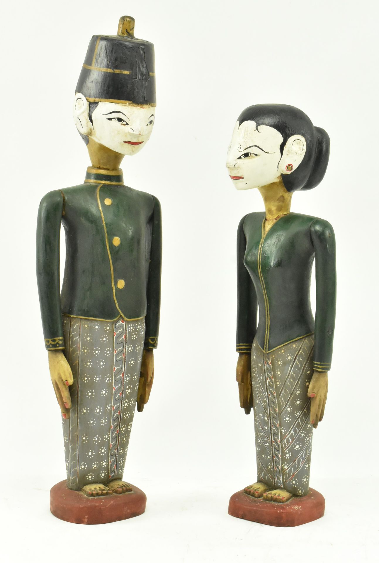 PAIR OF 20TH CENTURY CARVED AND PAINTED BALINESE FIGURES