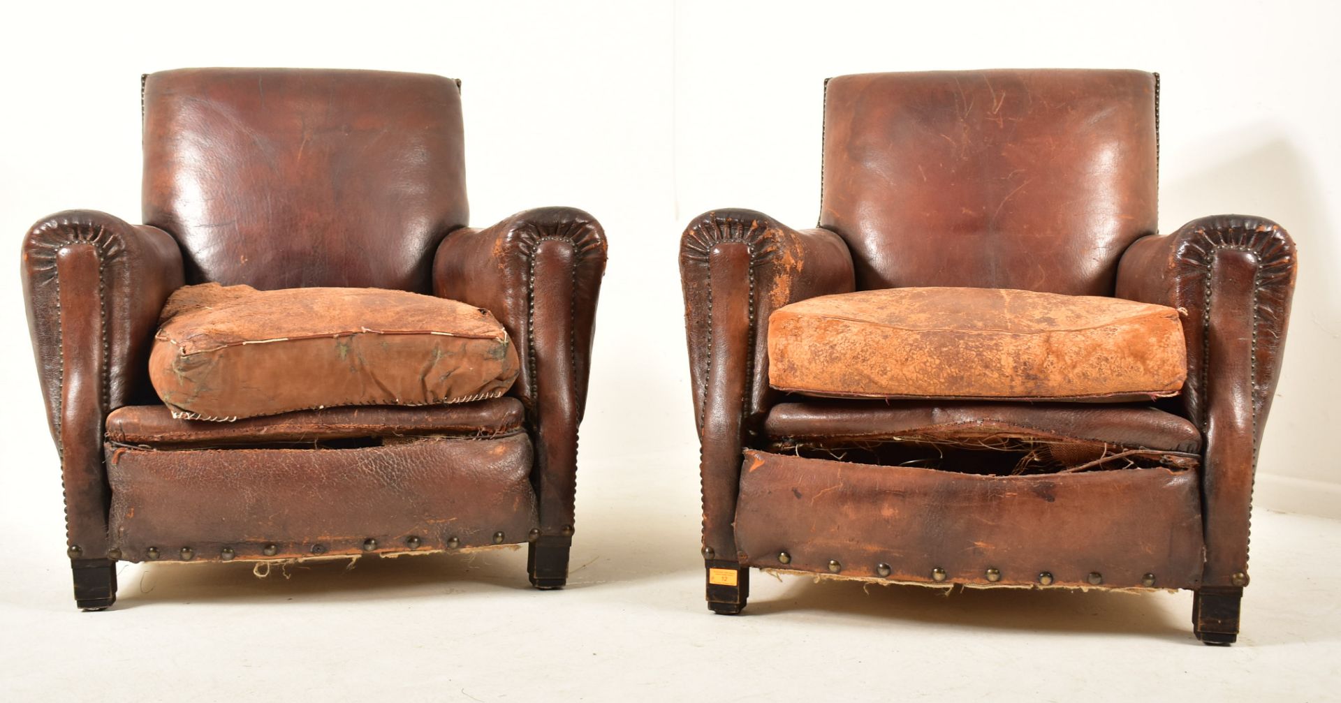 PAIR OF ART DECO LEATHER AND BRASS STUDDED CLUB ARMCHAIRS