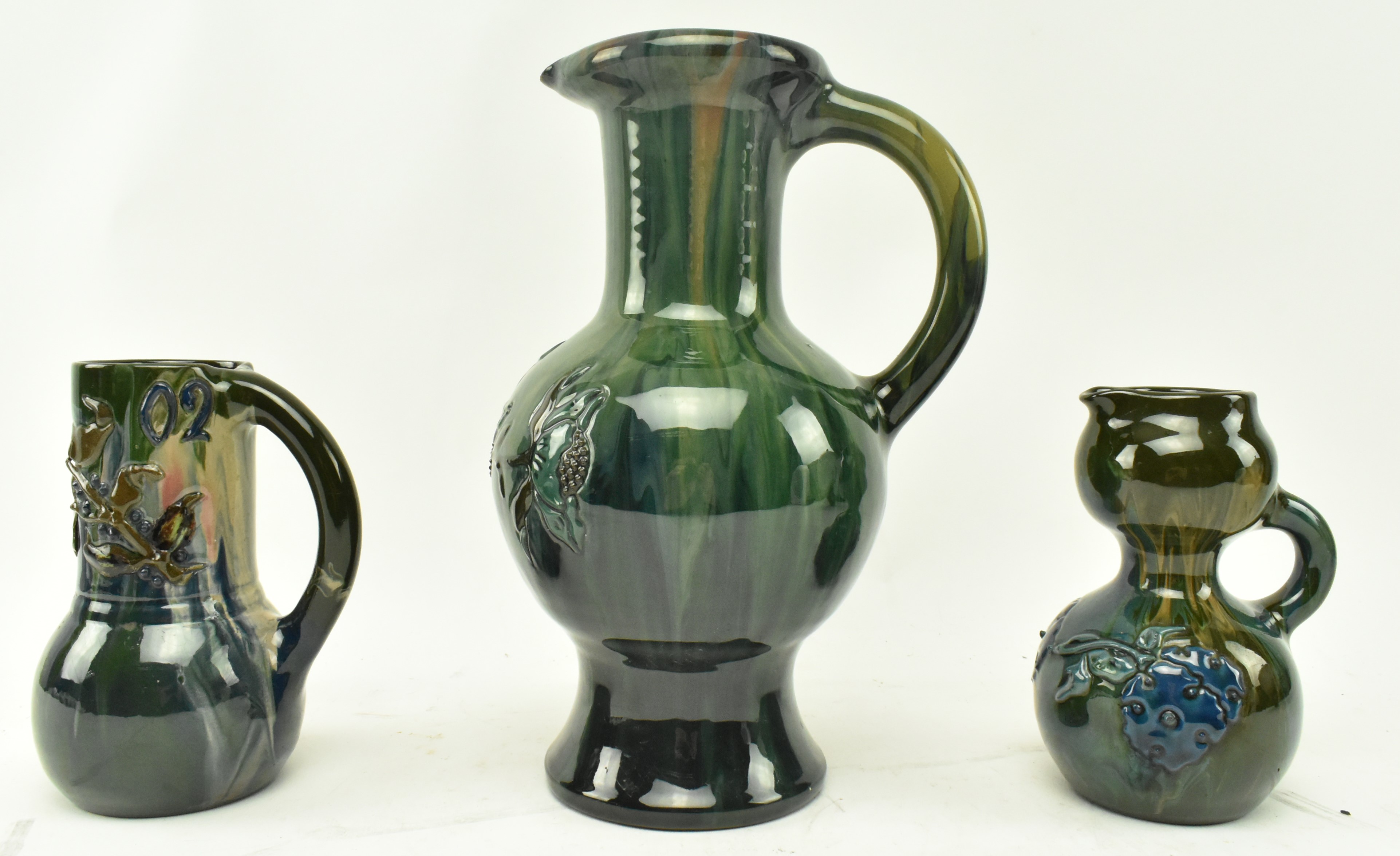 ELTONWARE POTTERY, CLEVEDON - THREE POTTERY HANDLED JUGS