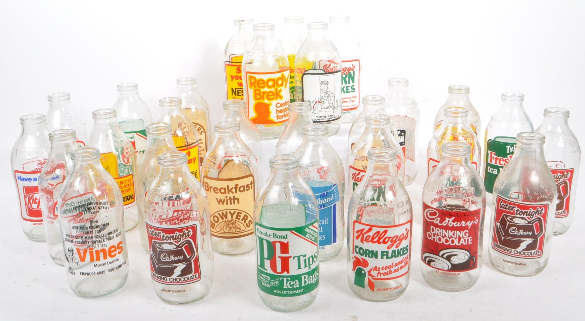 COLLECTION OF VINTAGE 1980S ADVERTISING MILK BOTTLES