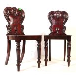 PAIR OF GEORGE III CARVED MAHOGANY HALL CHAIRS