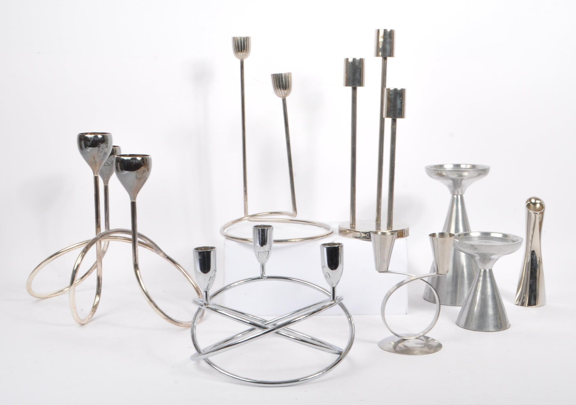 COLLECTION OF EIGHT 1980S STAINLESS STEEL CANDLE HOLDERS