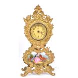 GILT METAL CONTINENTAL MANTEL CLOCK WITH COURTING SCENE