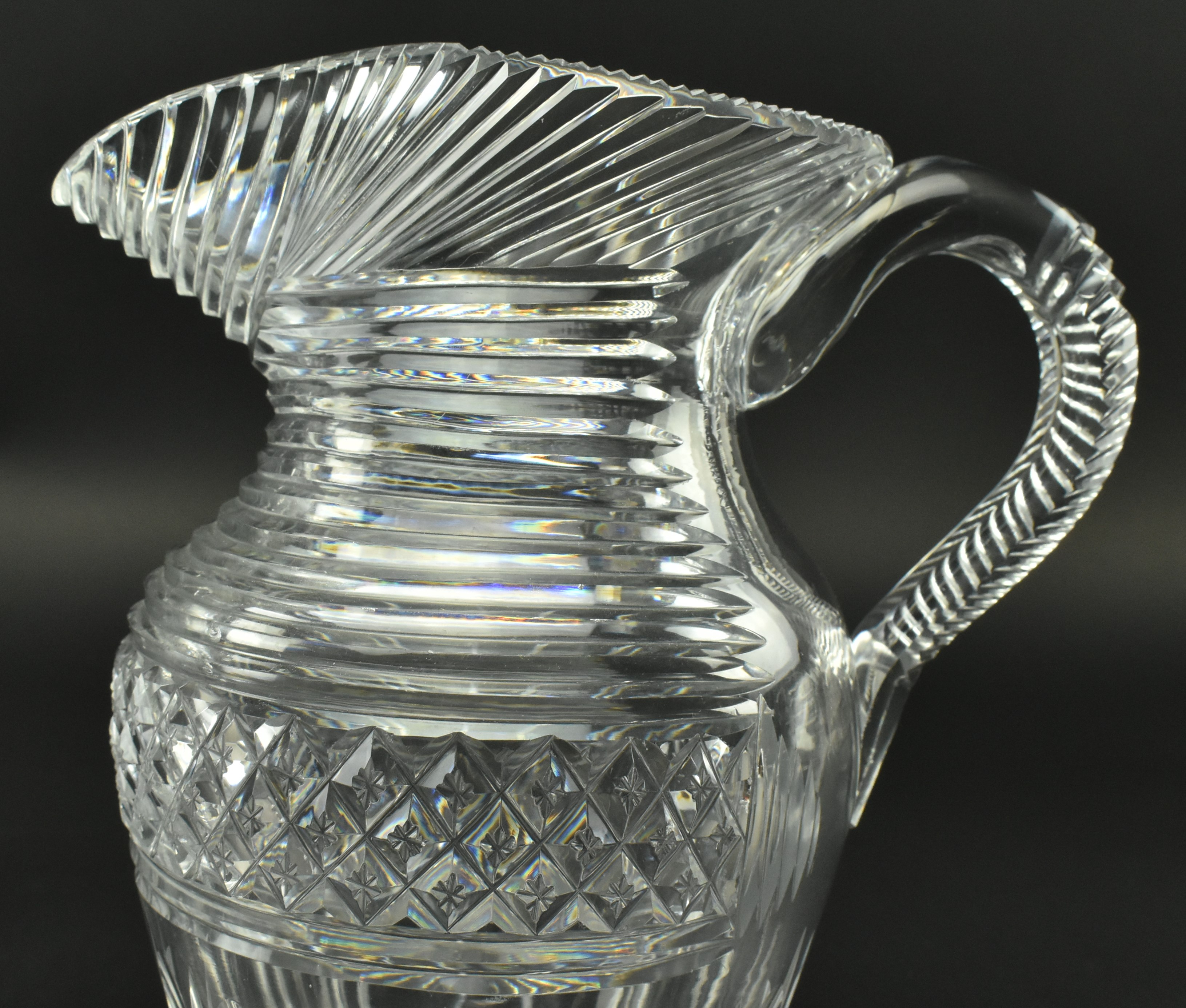 FOUR EARLY 19TH CENTURY GLASS JUGS WITH STEP CUT DESIGN - Image 5 of 11