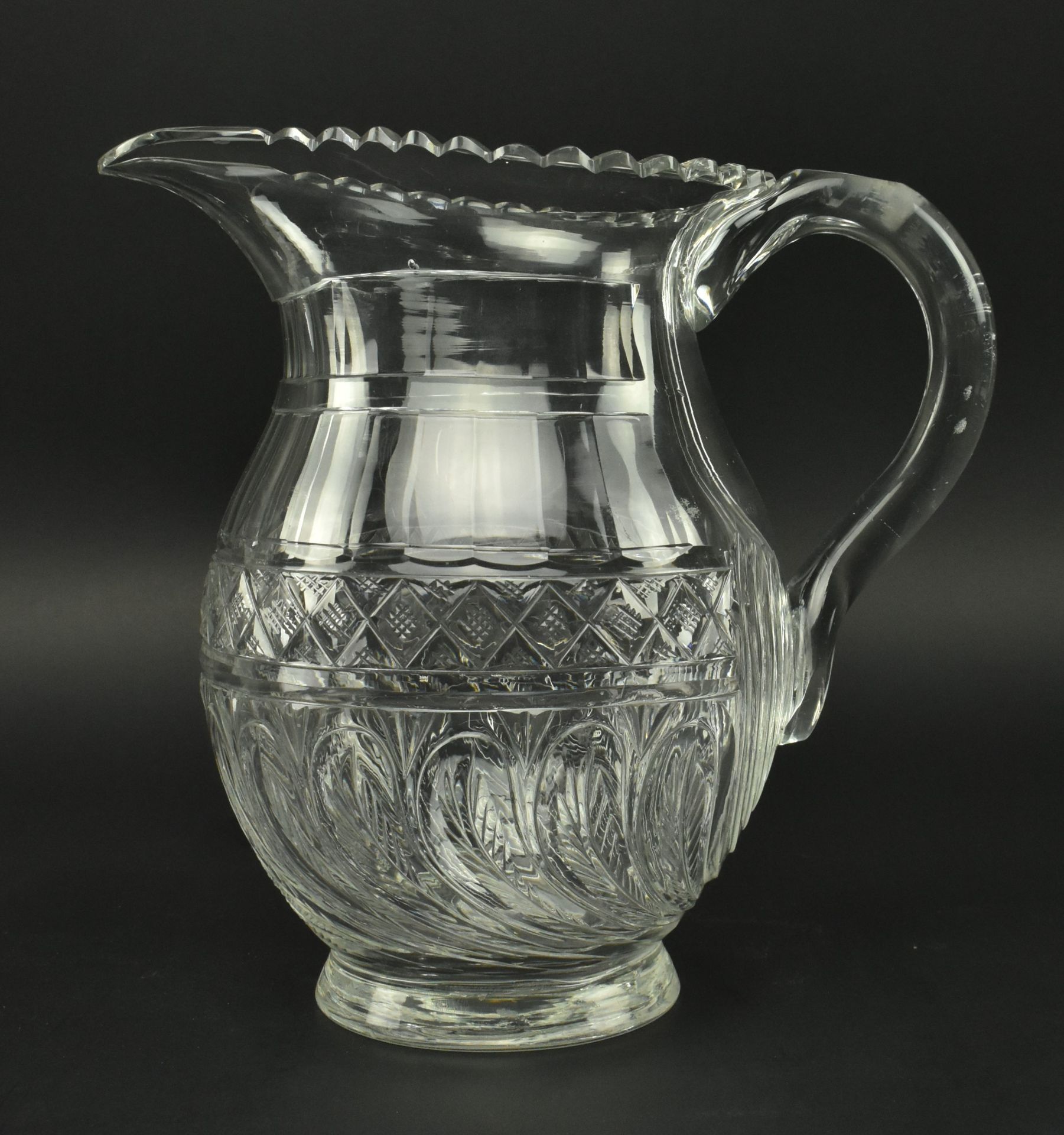 EARLY 19TH CENTURY GLASS WATER JUG, FEATHERED DESIGN