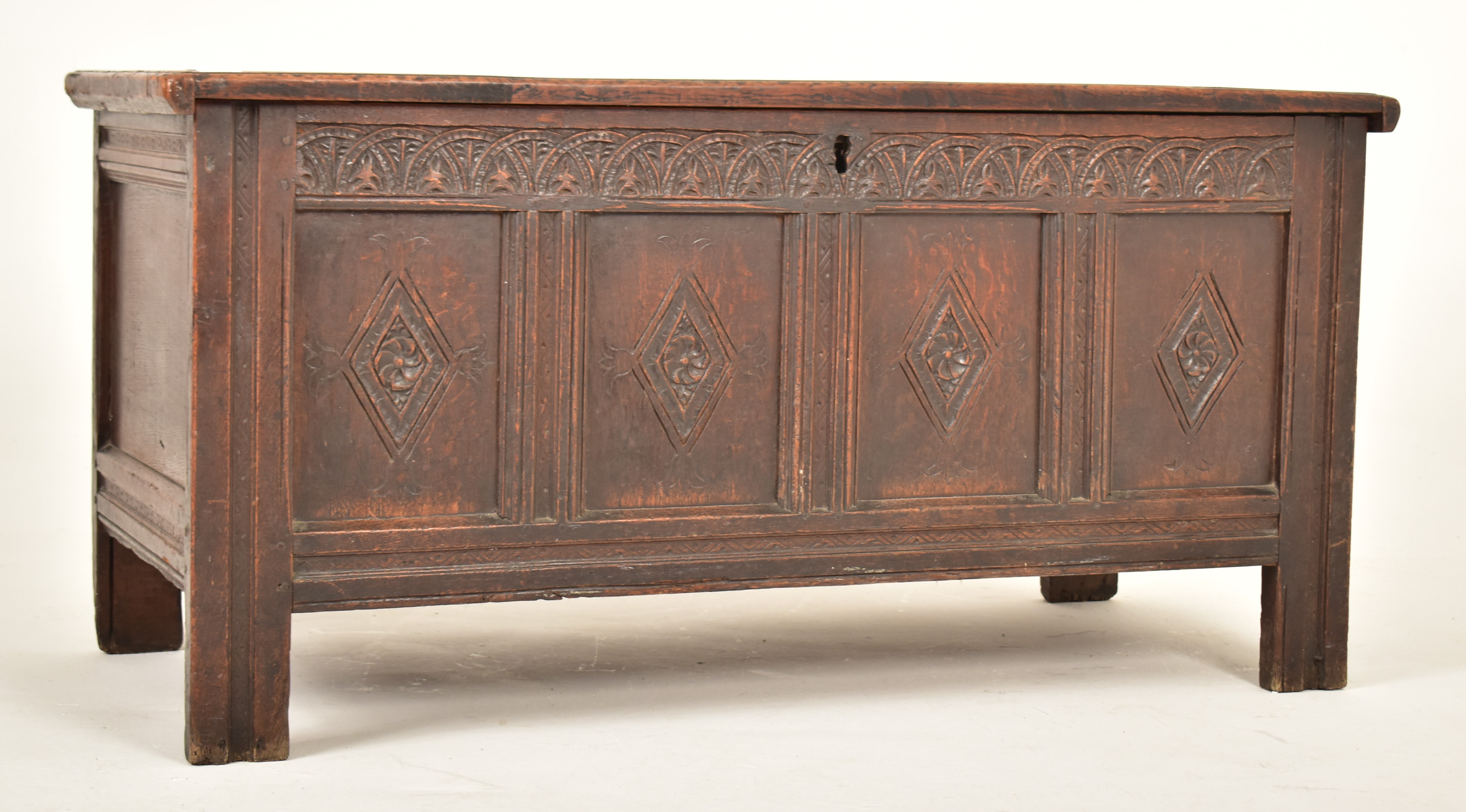 LATE 17TH CENTURY CARVED OAK HINGED TOP TRUNK CHEST