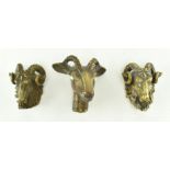 COLLECTION OF THREE BRONZE MODELLED HEADS OF RAMS