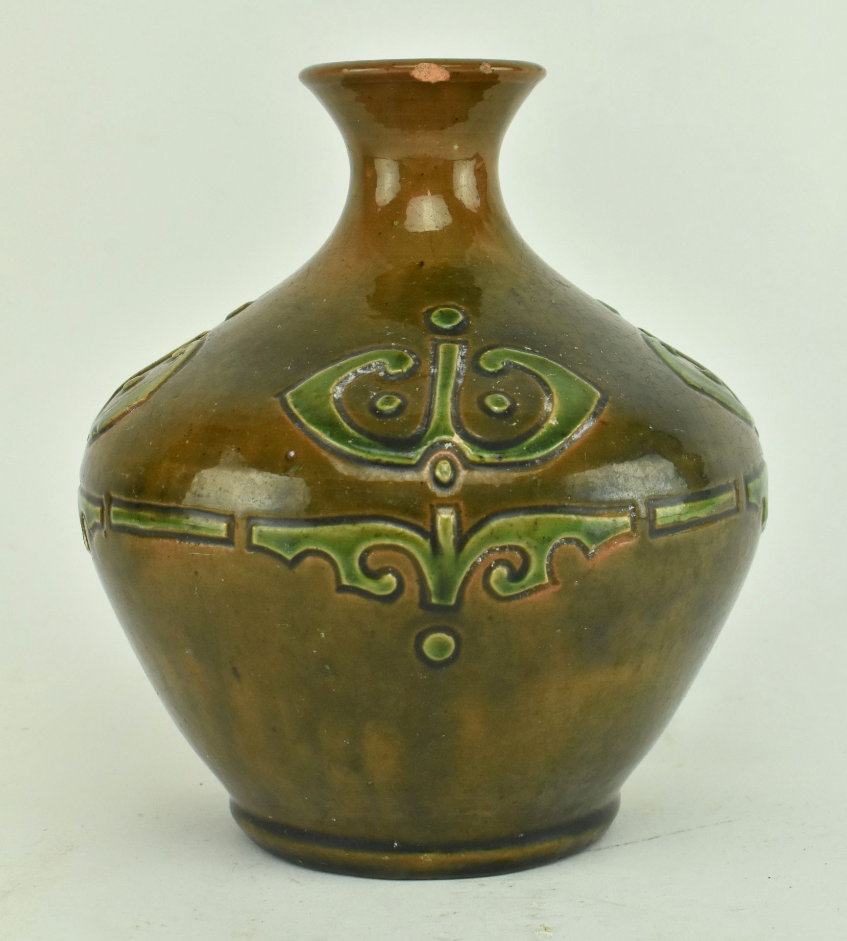 CONTINENTAL GREEN AND BROWN GLAZED POTTERY WITH RELIEF MOTIF