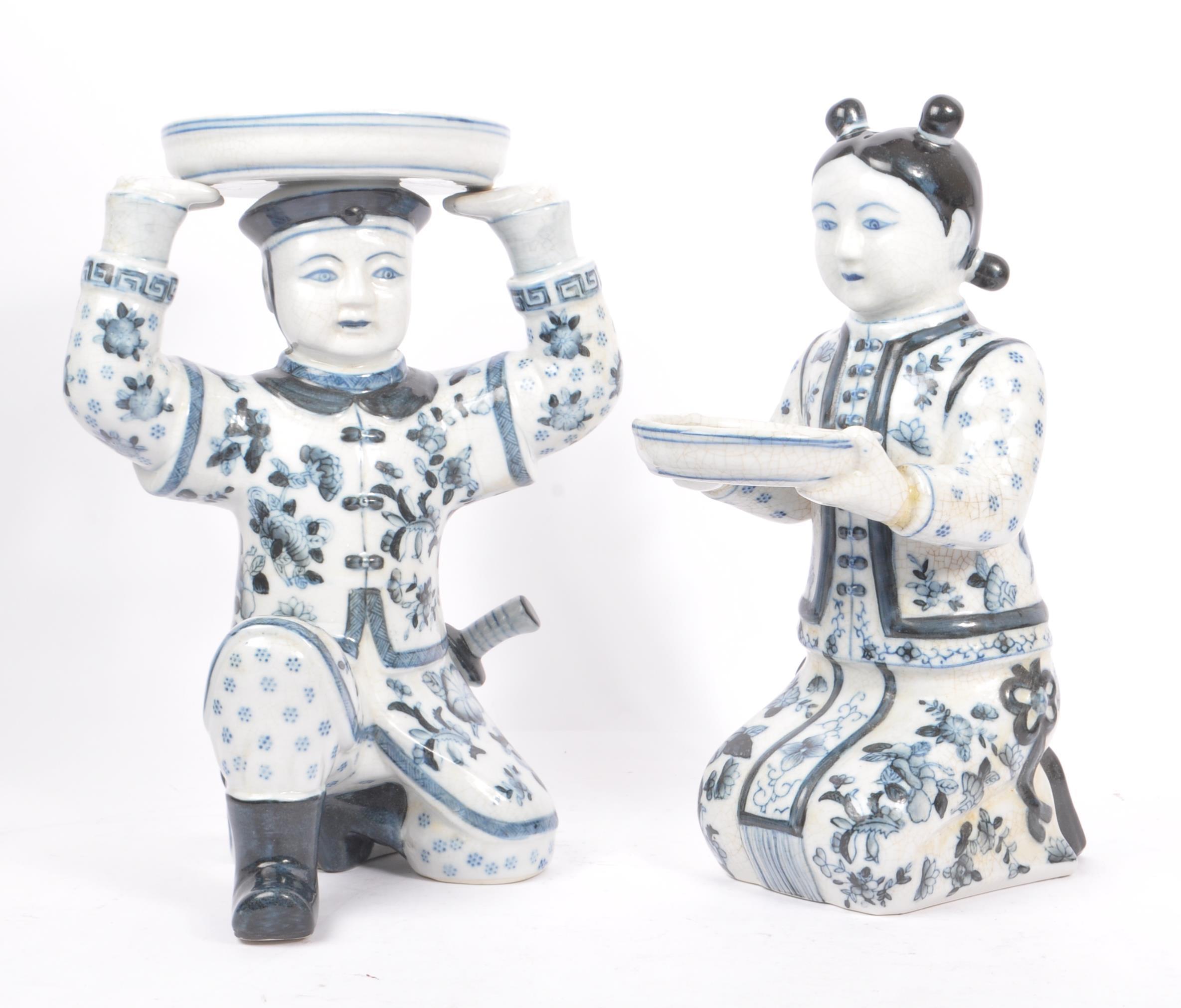 TWO 1920S CHINESE BLUE AND WHITE FIGURES HOLDING BOWLS