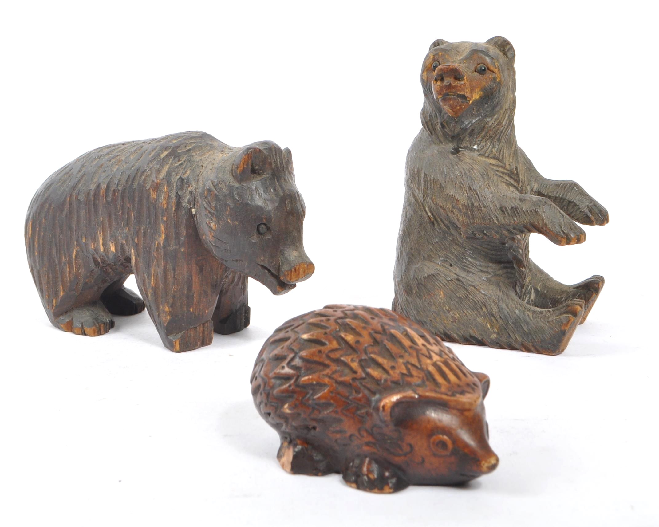 TWO BLACK FOREST HAND CARVED WOODEN BEARS WITH HEDGEHOG