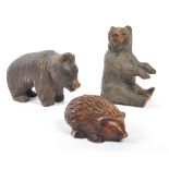 TWO BLACK FOREST HAND CARVED WOODEN BEARS WITH HEDGEHOG