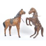 MANNER OF LIBERTY & CO - TWO LARGE LEATHER HORSES