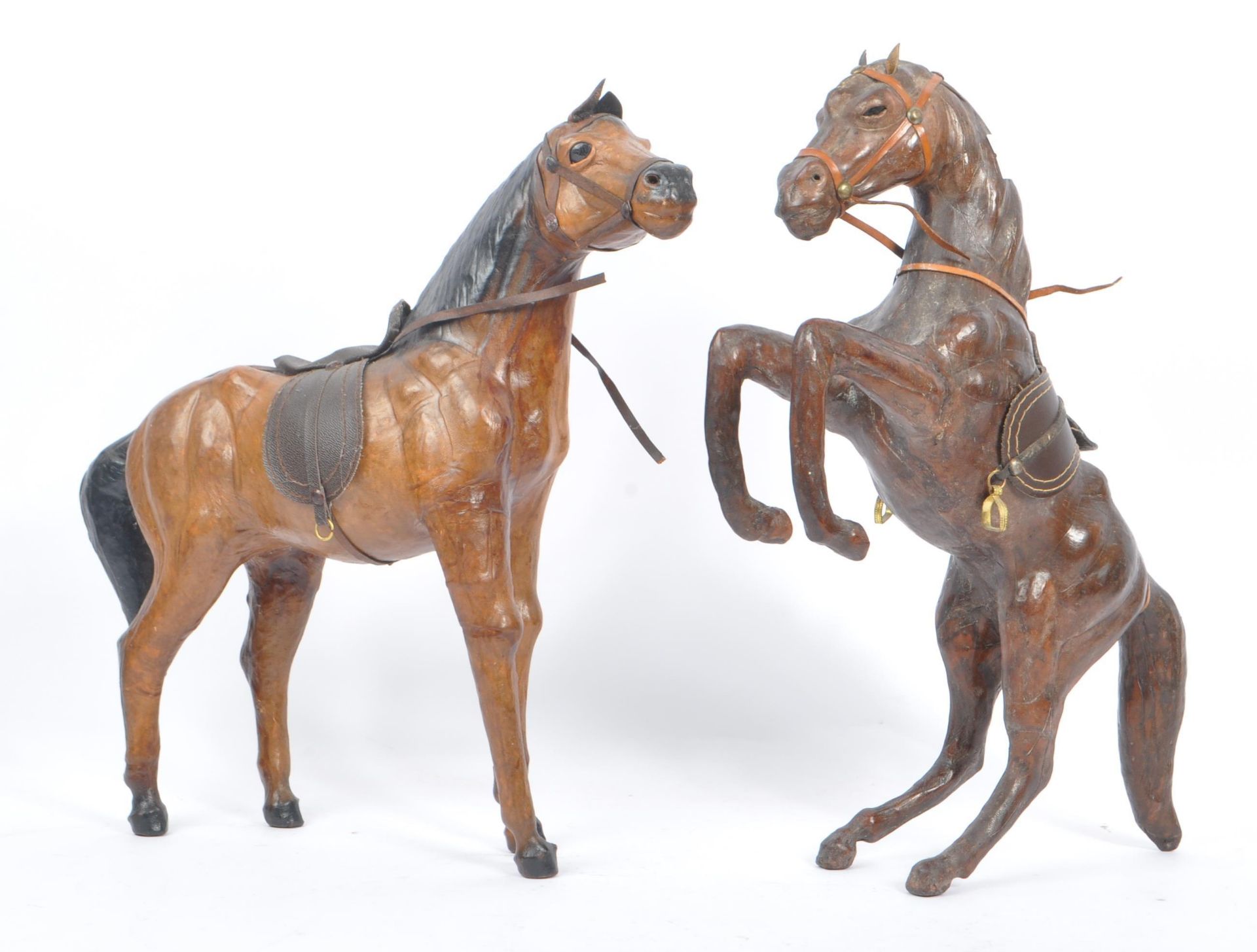 MANNER OF LIBERTY & CO - TWO LARGE LEATHER HORSES