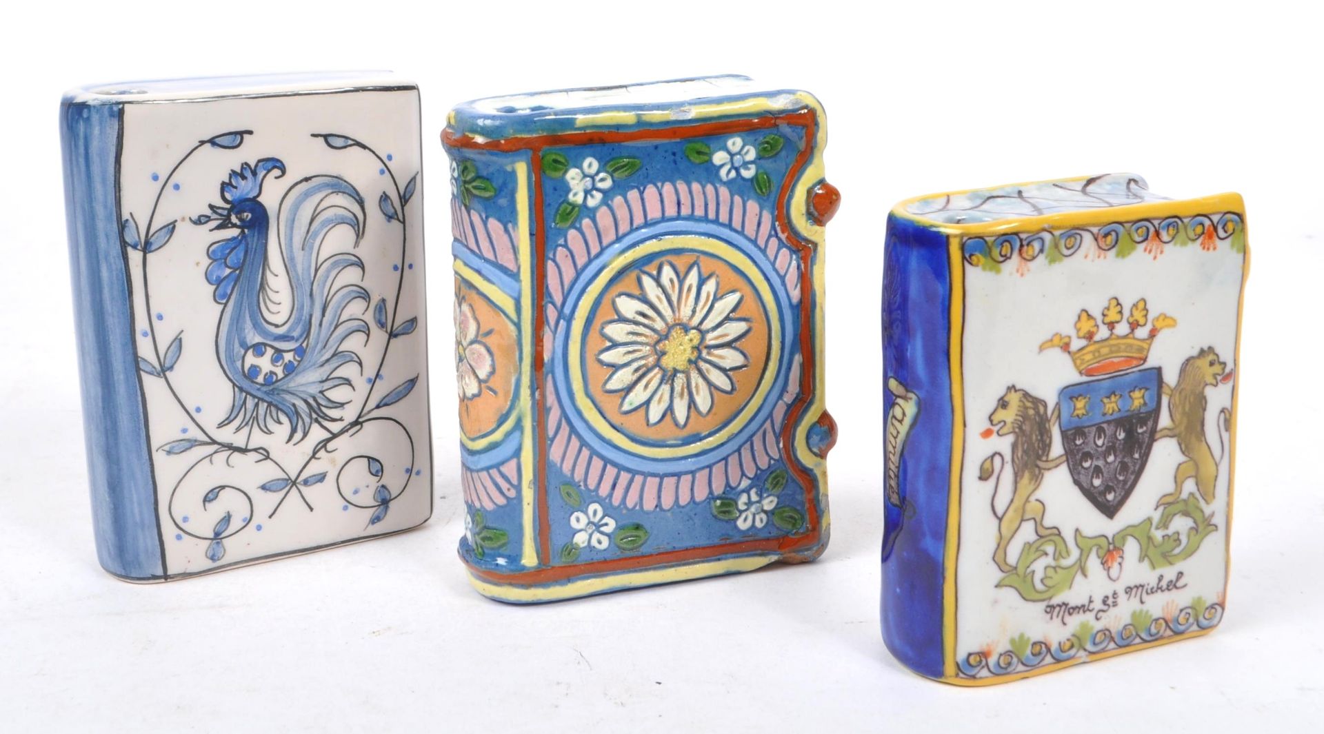 THREE CERAMIC HAND PAINTED BOTTLES IN THE FORM OF BOOKS