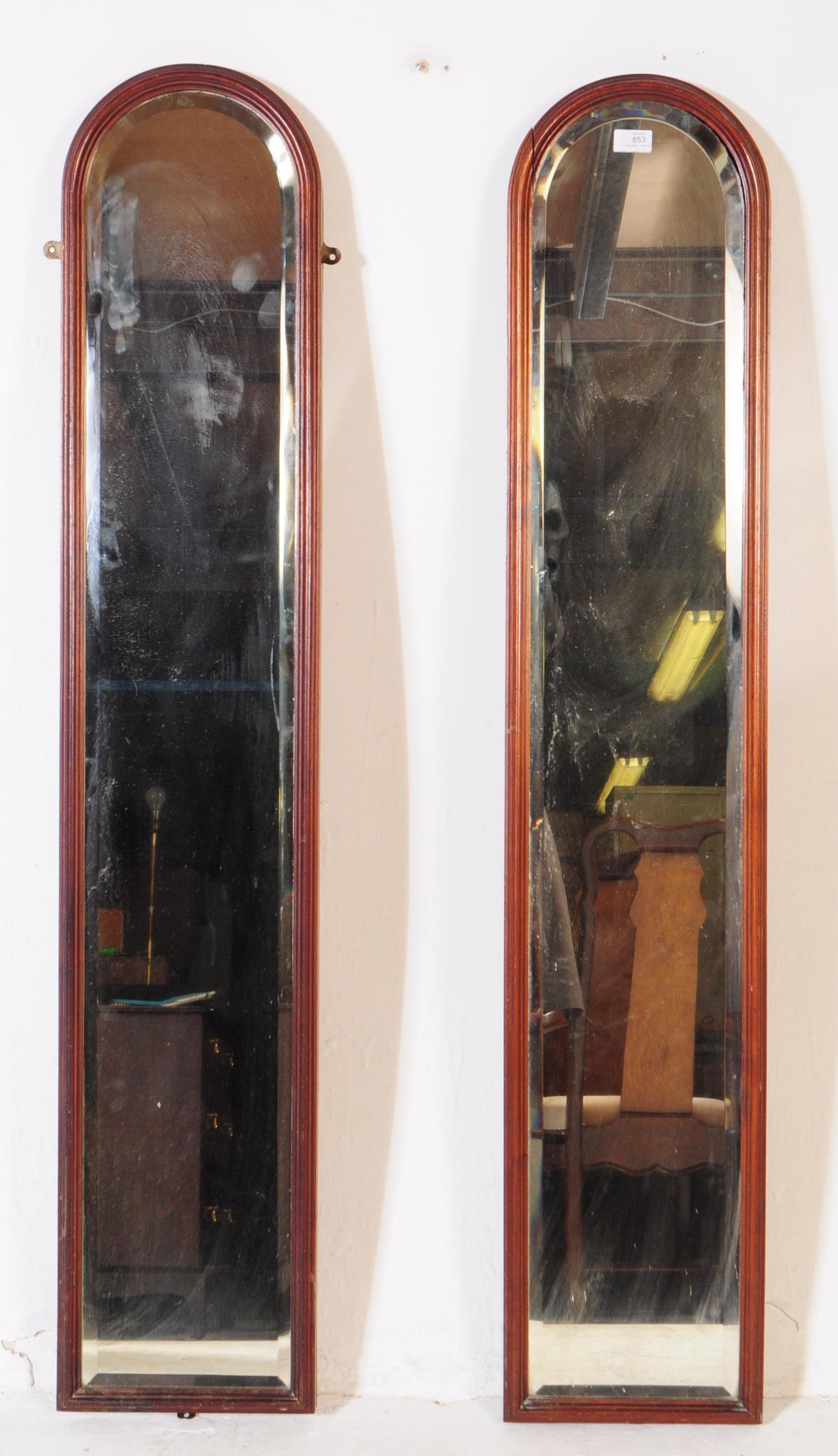 PAIR OF 1920S ELONGATED ARCHED WALL MIRRORS