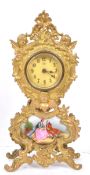 GILT METAL CONTINENTAL MANTEL CLOCK WITH COURTING SCENE